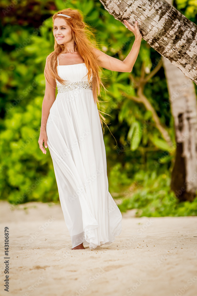outdoor portrait of young happy smiling woman on natural tropical background