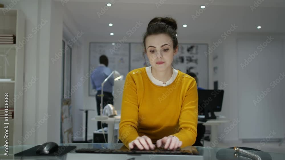 Young woman working on computer in creative office Young woman working on computer in creative office