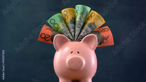 Pink Piggy bank money concept on dark blue background photo