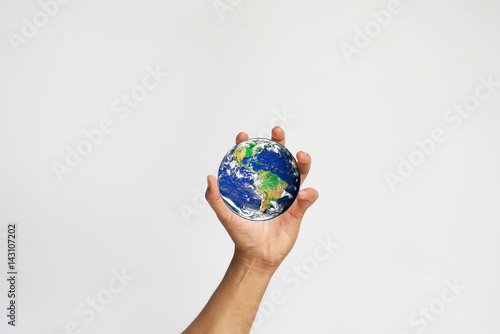 Hands with earth (Elements of this image furnished by NASA)