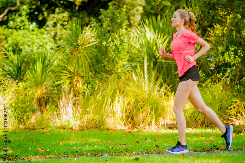 Woman runner running jogging in summer park Woman runner running jogging in summer park