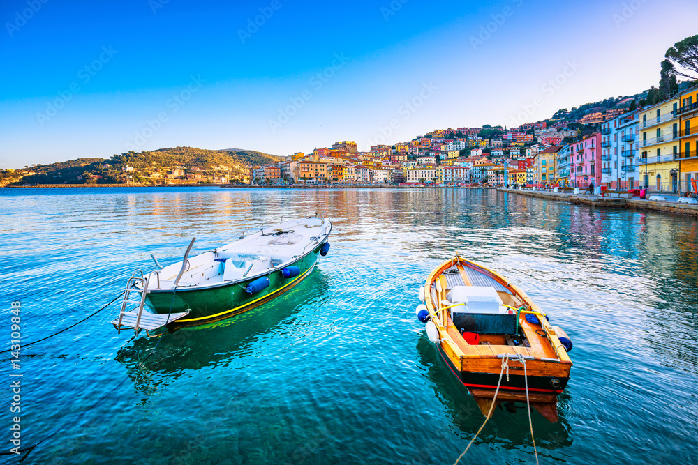 Wooden small boats in Porto Santo Stefano seafront. Argentario, Tuscany, Italy - obrazy, fototapety, plakaty 