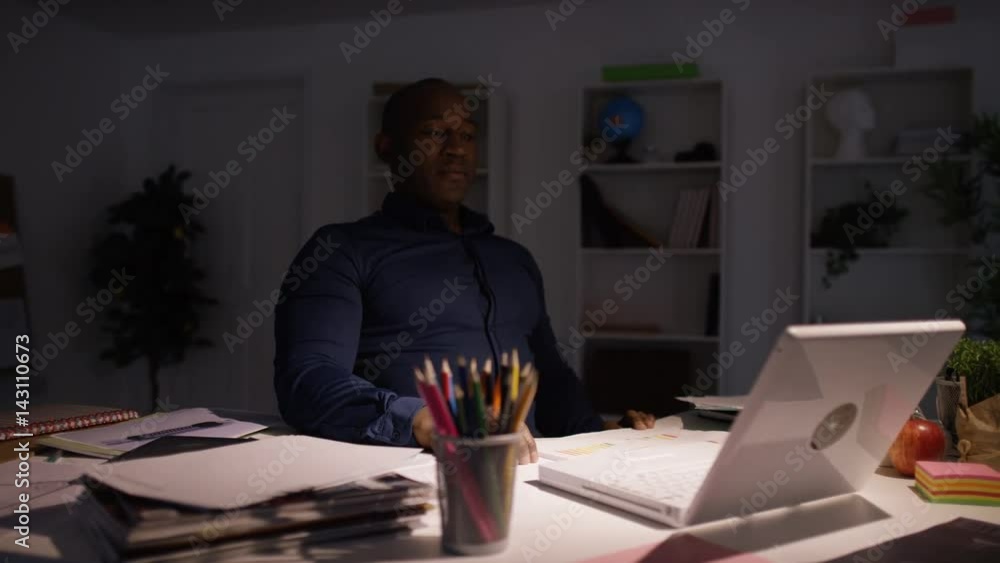 Entrepreneur businessman working late closing computer & finishing for the day Entrepreneur businessman working late closing computer & finishing for the day