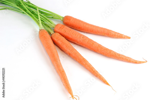fresh carrot with leaves isolated on white background