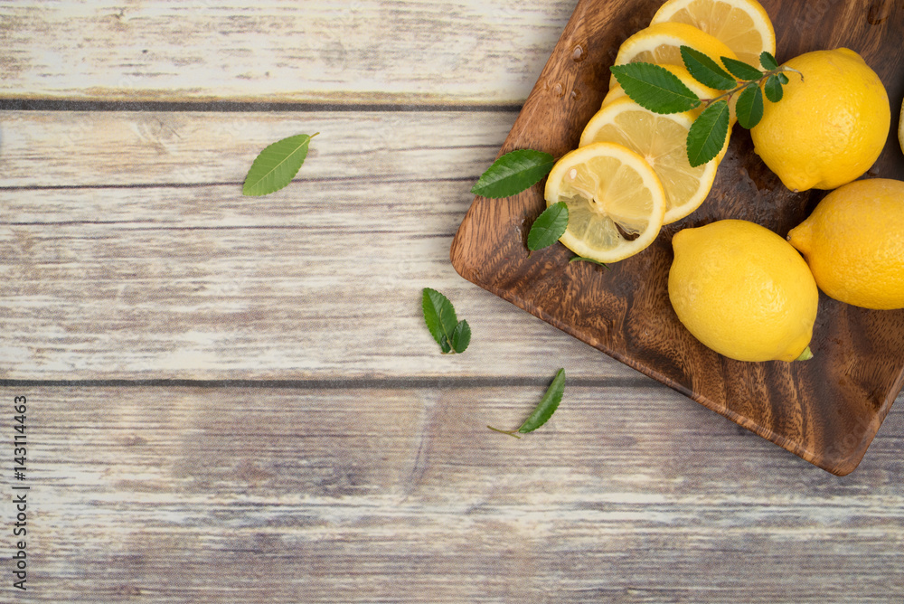 Lemons in a wooden plate Lemons in a wooden plate