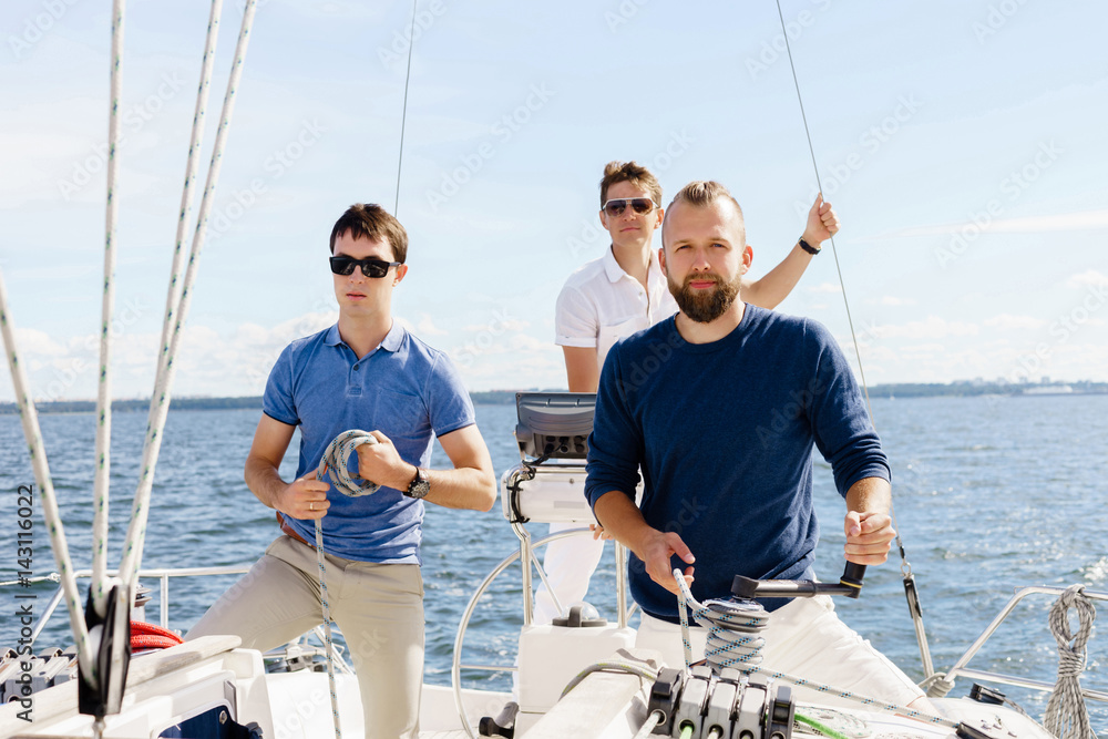 Group of happy friends traveling on a yacht. Tourism, vacation, holiday, concept. Group of happy friends traveling on a yacht. Tourism, vacation, holiday, concept.