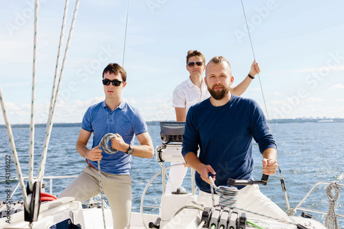 Group of happy friends traveling on a yacht. Tourism, vacation, holiday, concept. © Acronym