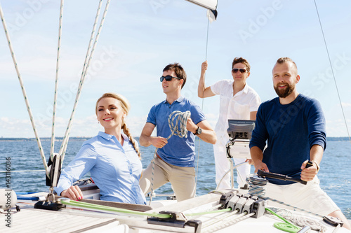 Group of happy friends traveling on a yacht. Tourism, vacation, holiday, concept.