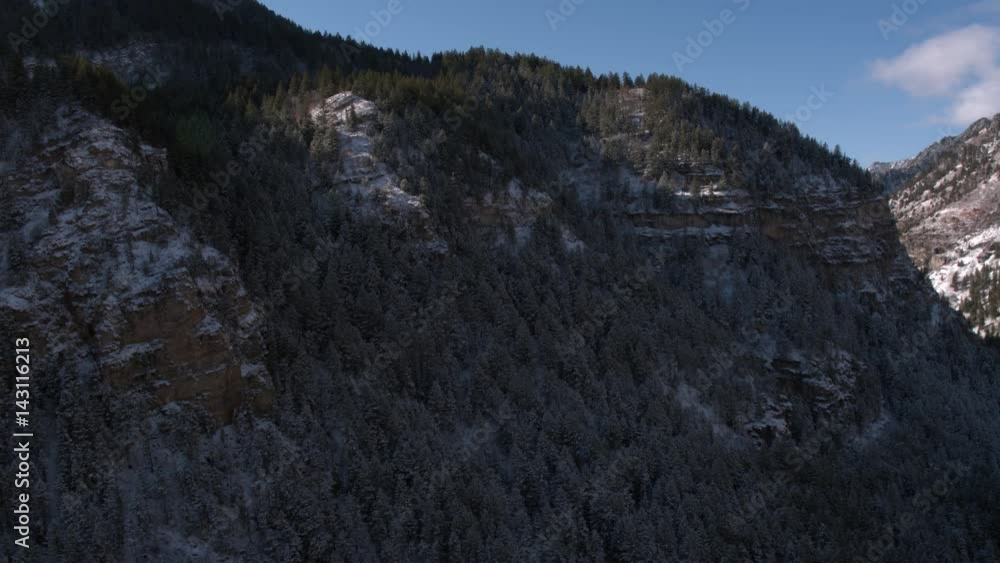 Panning view flying toward snow cover hillside in canyon Panning view flying toward snow cover hillside in canyon