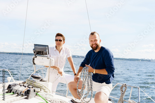 Two happy friends traveling on a yacht. Vacation, tourism, holiday, concept. © Acronym