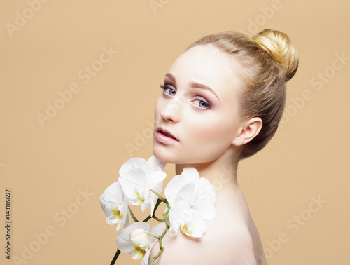 Beauty close-up portrait of beautiful, fresh and healthy girl over yellow background.