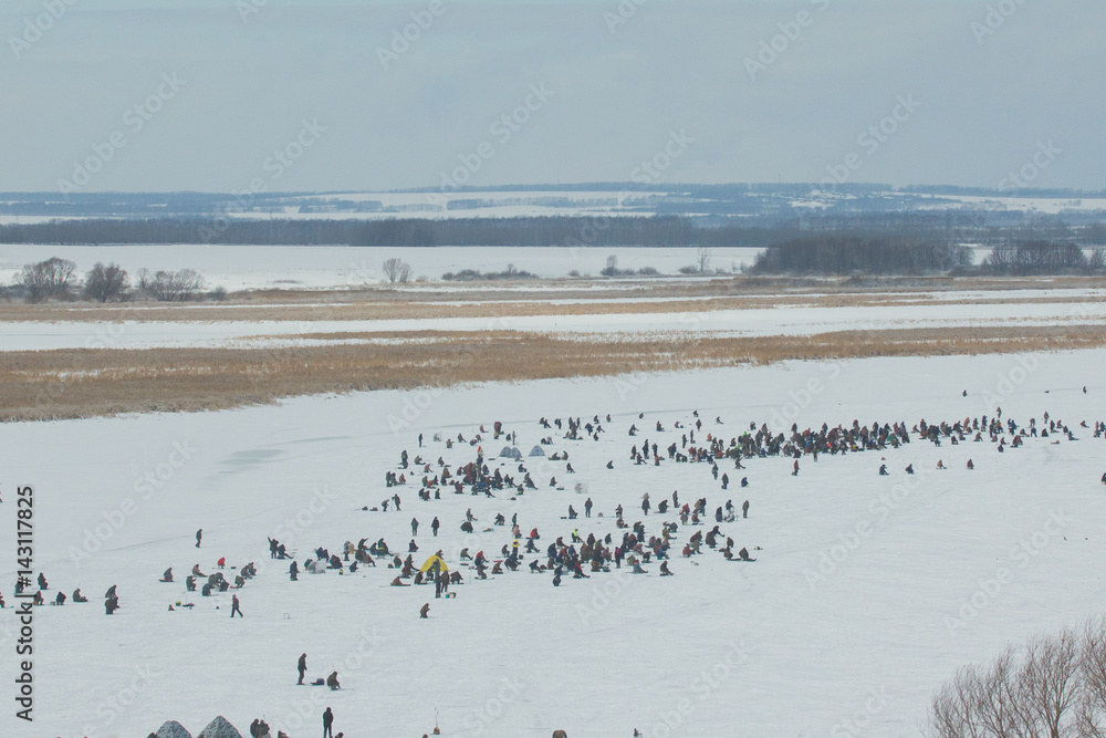 Winter fishing - crowd of People at ice frozen river