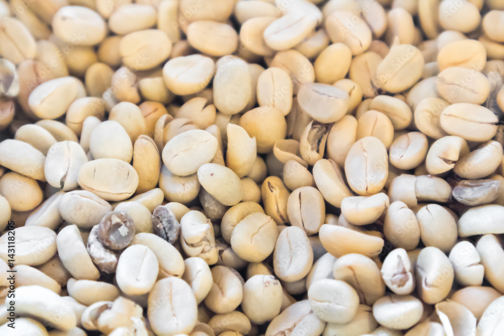 Close up raw green coffee beans unroasted background and texture concept, selective focus Close up raw green coffee beans unroasted background and texture concept, selective focus