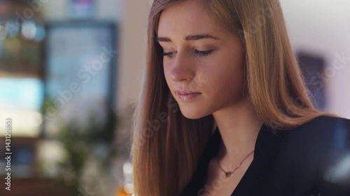 Wallpaper Mural The blonde-haired girl in the black jacket is sitting in the café. She is texting with a friend while eating her lunch. Torontodigital.ca
