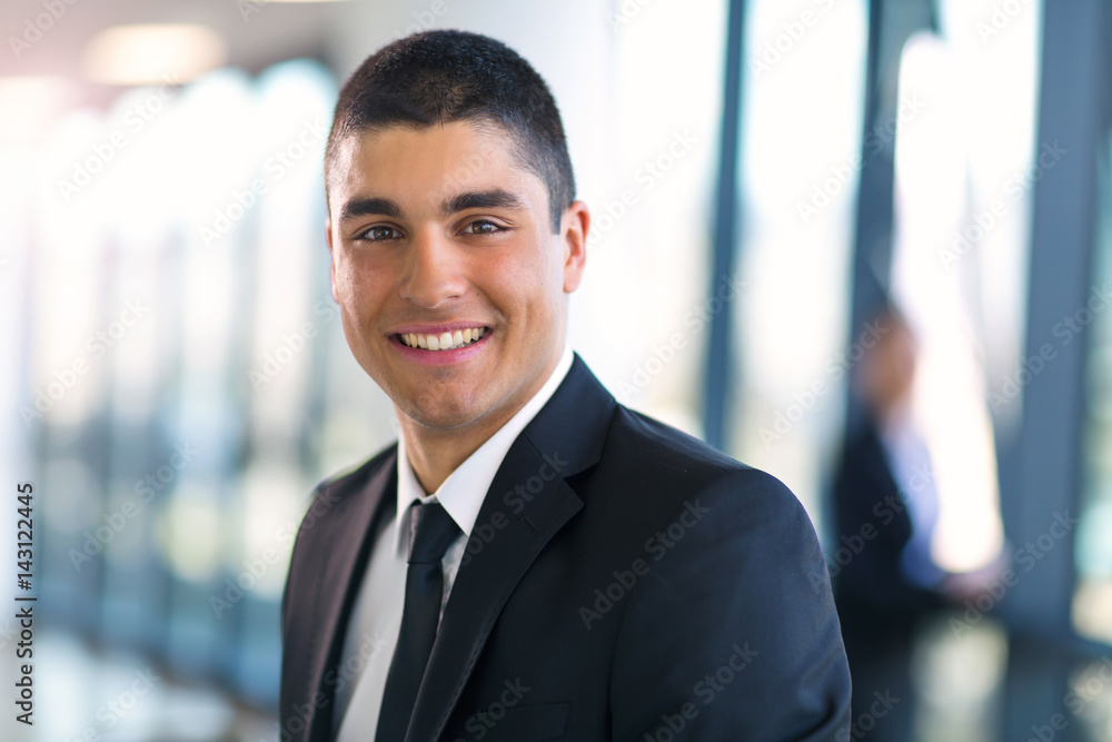 Smart business man posing in office building Smart business man posing in office building