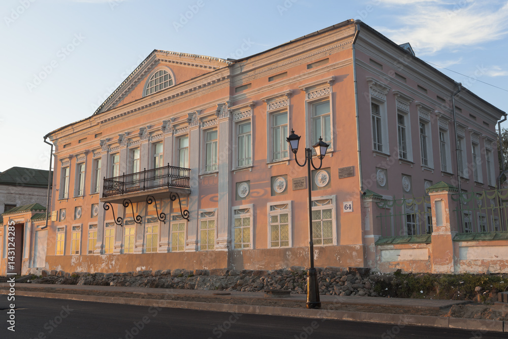Building of the Museum of History and Culture of Veliky Ustyug is the former home of merchant Grigory Vasilievich Usov in the rays of the setting sun, Vologda region, Russia