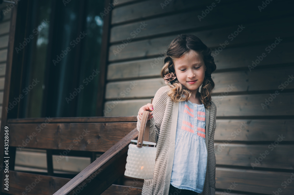 child girl with candle holder relaxing in evening at cozy country house. Kid spending summer vacation in log cabin in the woods child girl with candle holder relaxing in evening at cozy country house. Kid spending summer vacation in log cabin in the woods