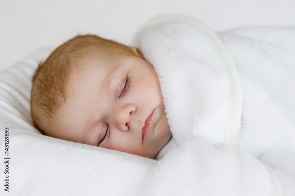 Cute little newborn baby girl sleeping wrapped in blanket Cute little newborn baby girl sleeping wrapped in blanket