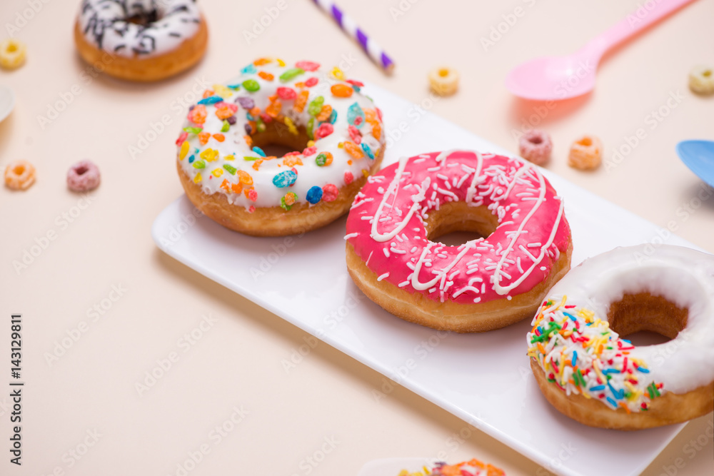 Party. Different colourful sugary round glazed donuts and bottles of drinks on light color background. Party. Different colourful sugary round glazed donuts and bottles of drinks on light color background.