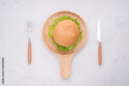 Eating delicious homemade burger on table. Top view, copy space, horizontal
