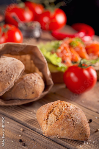 Multigrain bread with slices of smoked salmon, chili pepper and tomatoes