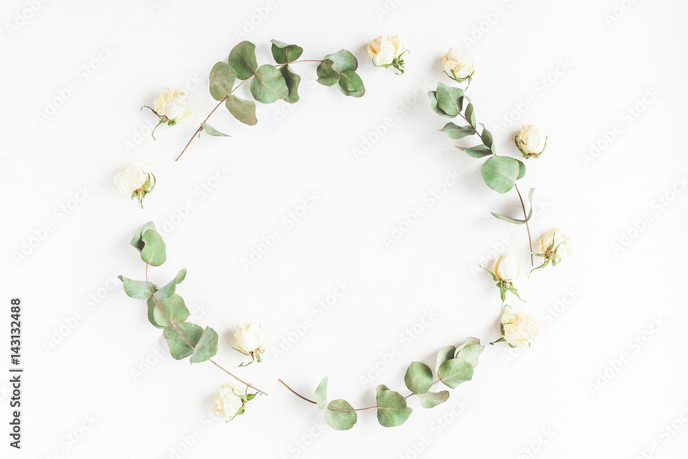 Flowers composition. Frame made of dried eucalyptus branches and rose flowers. Flat lay, top view Flowers composition. Frame made of dried eucalyptus branches and rose flowers. Flat lay, top view
