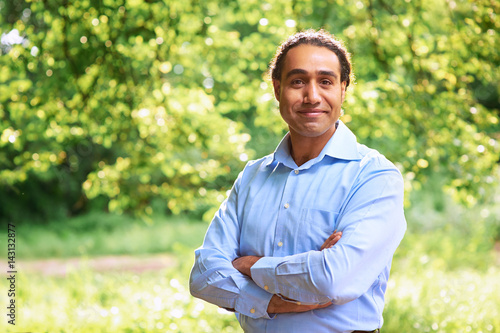 Portrait of a mature dark skin man standing with arms crossed