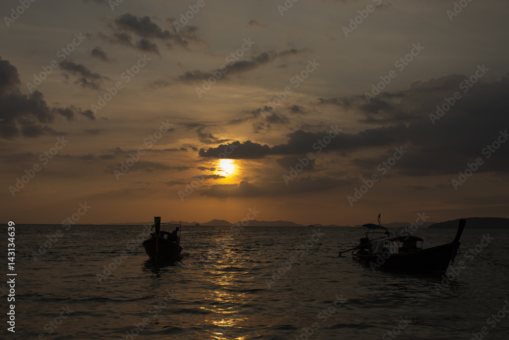 Traditional thai longtail boat at sunset on the Beach. Thailand, Krabi province