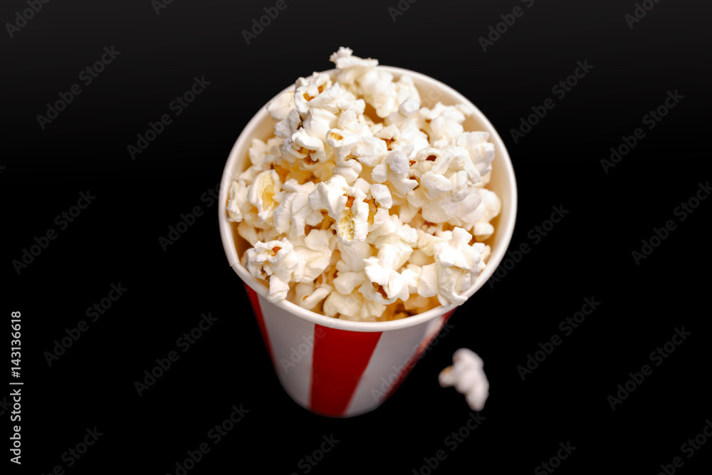 Popcorn in red and white cardboard box. Popcorn border isolated on white. Film. Fast food. Corn Popcorn in red and white cardboard box. Popcorn border isolated on white. Film. Fast food. Corn