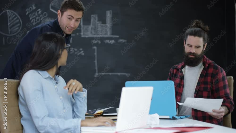 Young team in startup company working together & discussing business plan Young team in startup company working together & discussing business plan