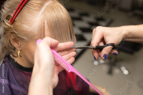 Female haircut with scissors