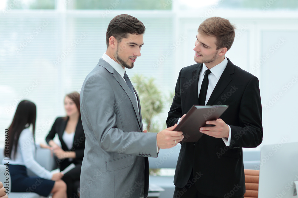 Group of young business people gathered together discussing crea Group of young business people gathered together discussing crea