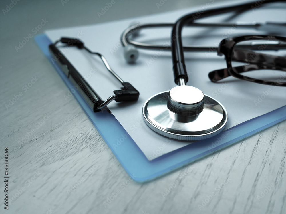 Stethoscope and file chart on doctor working desk with blurred focus for background, business and health care concept Stethoscope and file chart on doctor working desk with blurred focus for background, business and health care concept