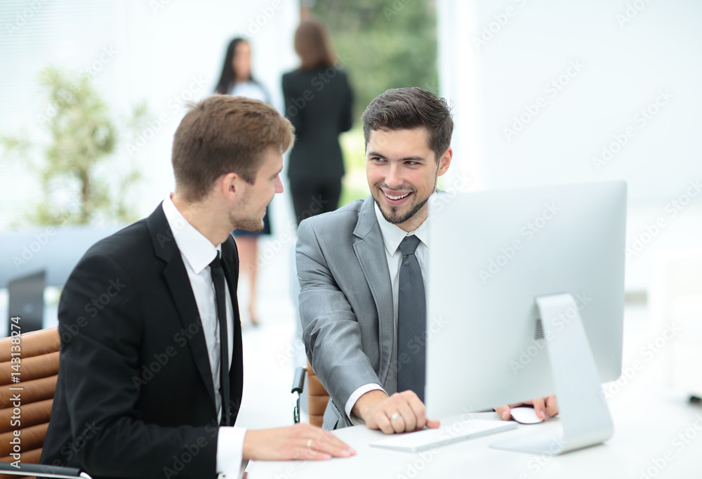 Two successful business men discussing documents in a modern off Two successful business men discussing documents in a modern off