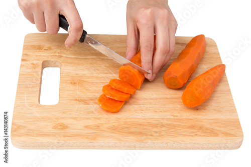 cook cuts carrots on a white background