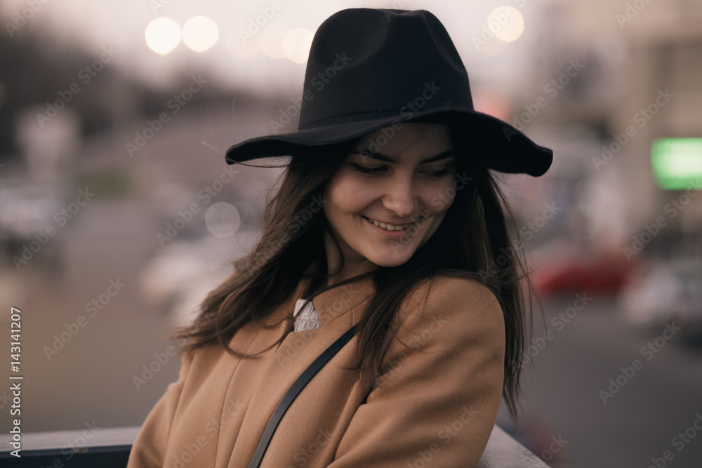 Funky woman in hat smiling and having fun, city background Funky woman in hat smiling and having fun, city background