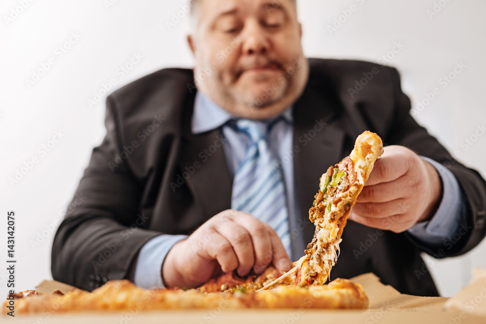 Chubby white collar worker enjoying his midday meal Chubby white collar worker enjoying his midday meal