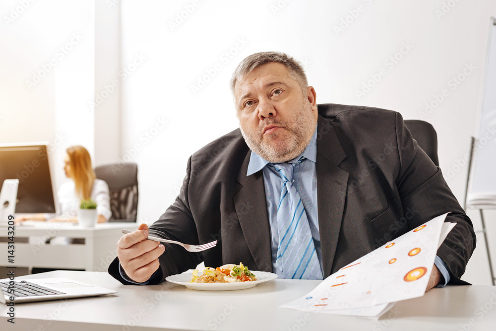 Hungry distressed worker looking overwhelmed Hungry distressed worker looking overwhelmed