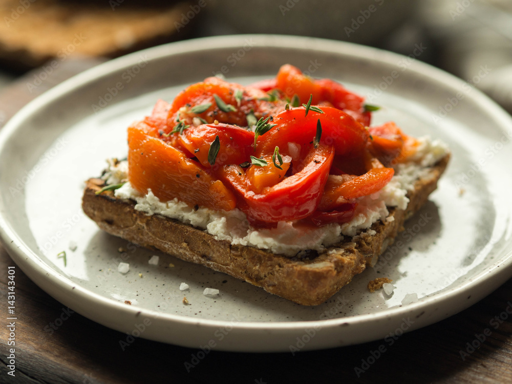 Vegetarian toast with baked pepper and cream cheese on a plate on a wooden board
Vegetarian toast with baked pepper and cream cheese on a plate on a wooden board