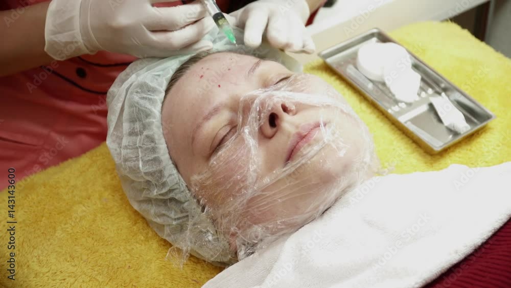 Beautician making injections for the woman in salon Beautician making injections for the woman in salon
