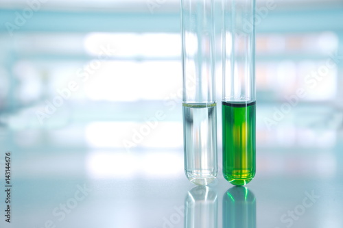 green and water of two test tube in science laboratory