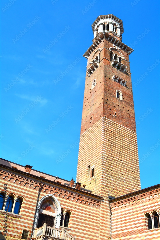 The ancient medieval tower in the blue sky of Verona called 