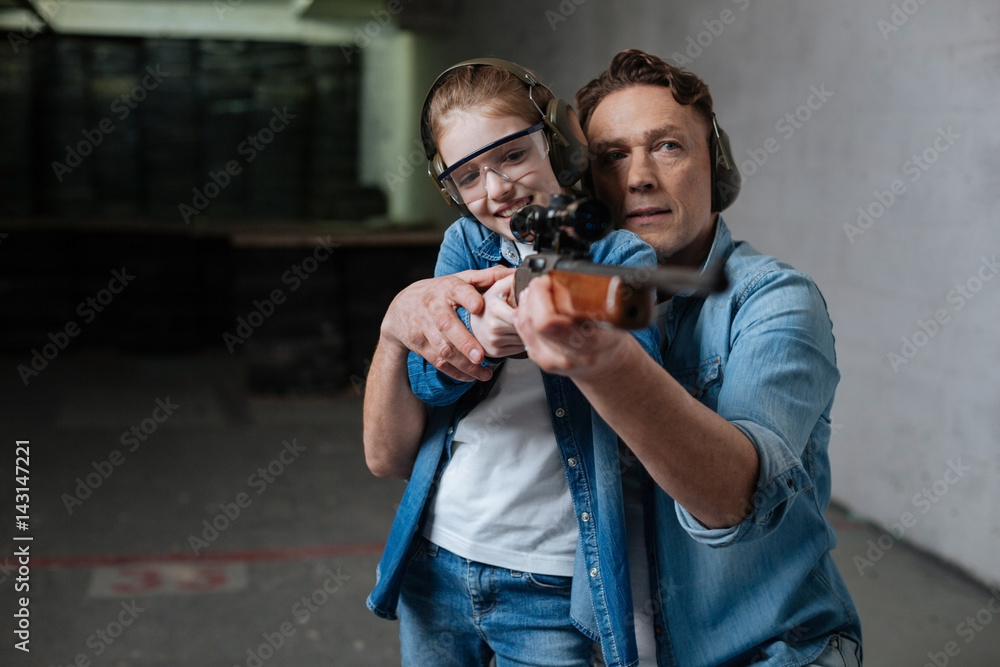 Cheerful positive girl trying to shoot Cheerful positive girl trying to shoot