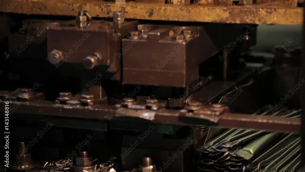Bending Metal, piece of metal is bended by a machine. Metal tableware manufacturing, piece of metalware Bending Metal, piece of metal is bended by a machine. Metal tableware manufacturing, piece of metalware
