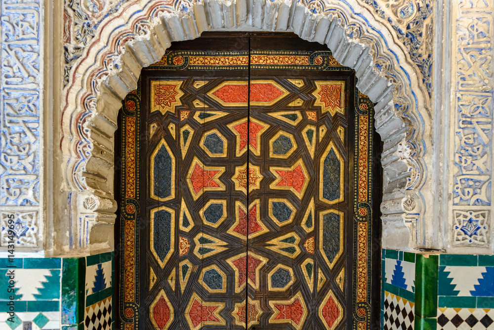 Decorated door in Mudejar palace of Alcazar, Seville, Spain