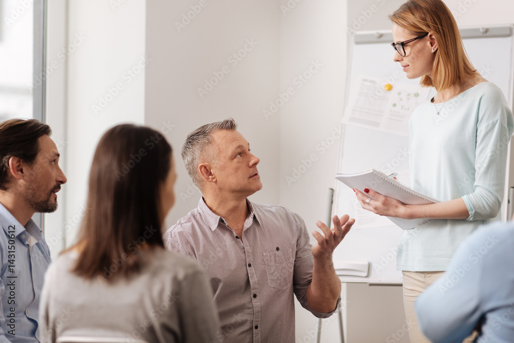 Conversation between office workers while posing on camera Conversation between office workers while posing on camera