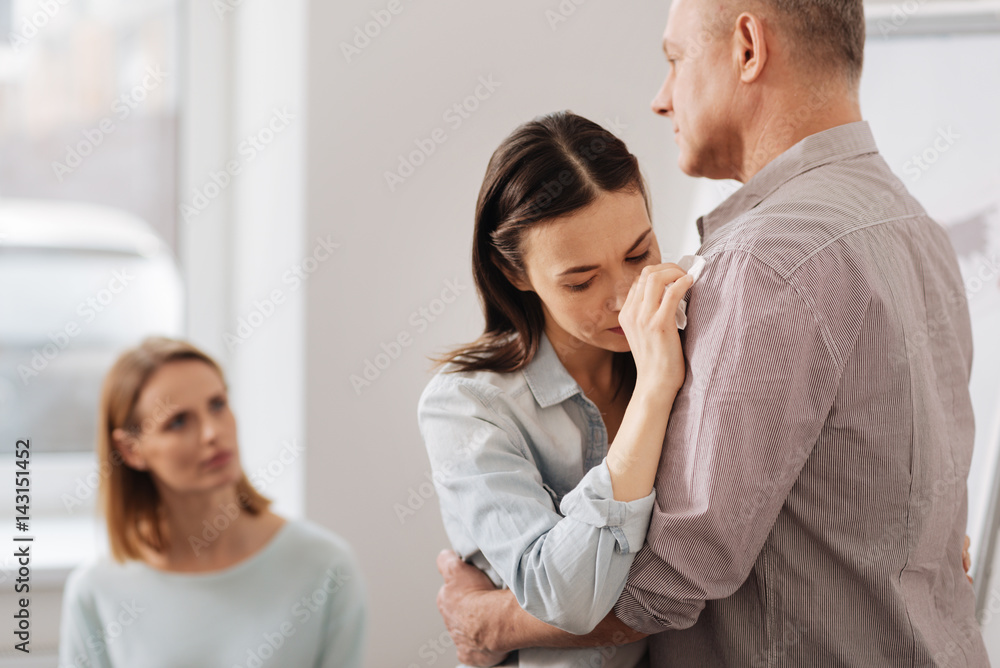 Portrait of upset brunette leaning on her colleague Portrait of upset brunette leaning on her colleague
