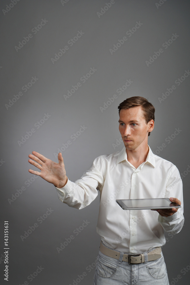 Young man with tablet computer works with a virtual interface. Young man with tablet computer works with a virtual interface.