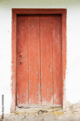 old house white wall with red door © nata777_7