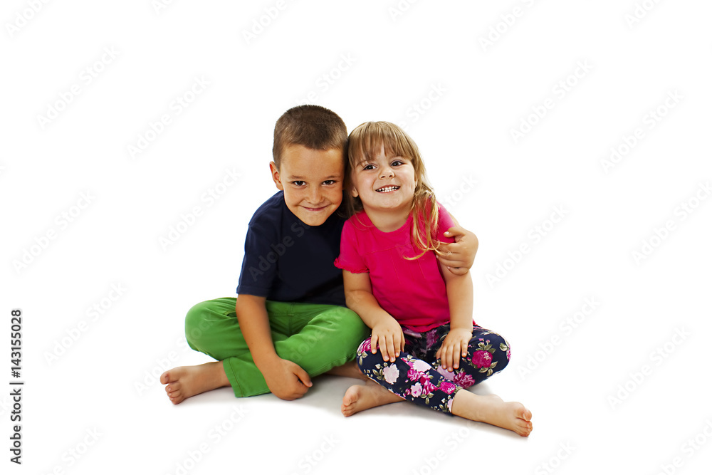 Loving sister and little brother hugging. Isolated on a white background.
Loving sister and little brother hugging. Isolated on a white background.